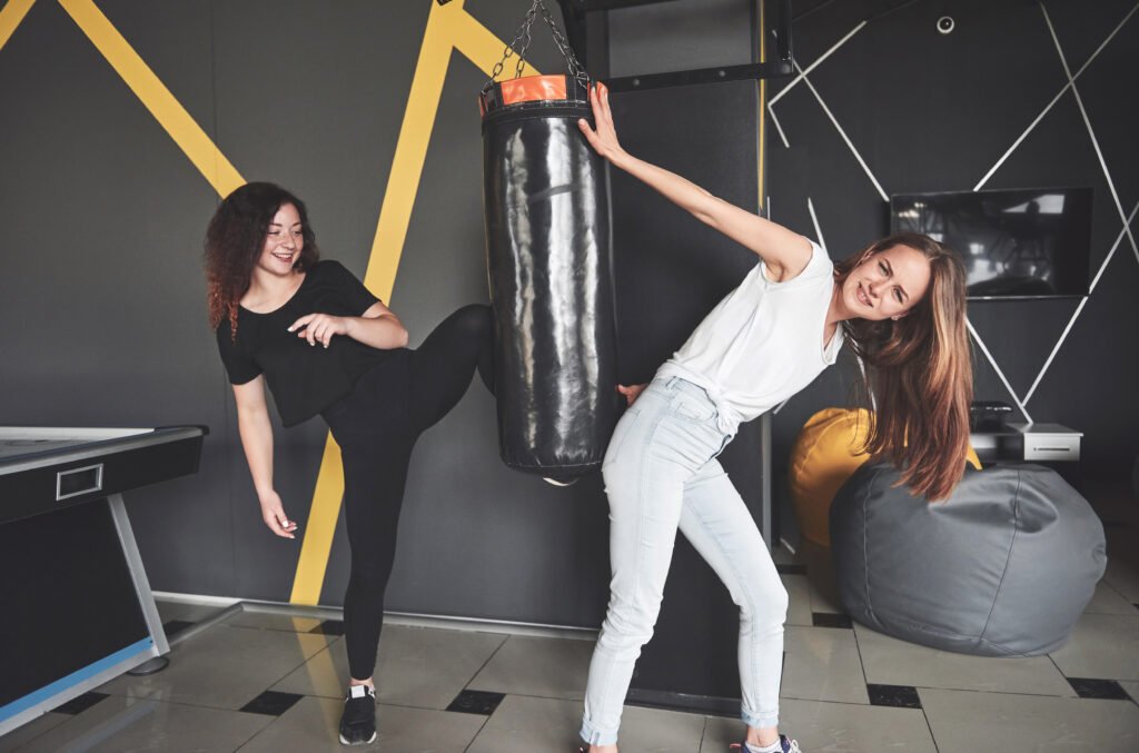 Portrait of fun boxers dressed in jeans and t-shirts in the gaming center
