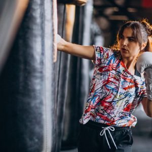 Young woman boxer training at the gym